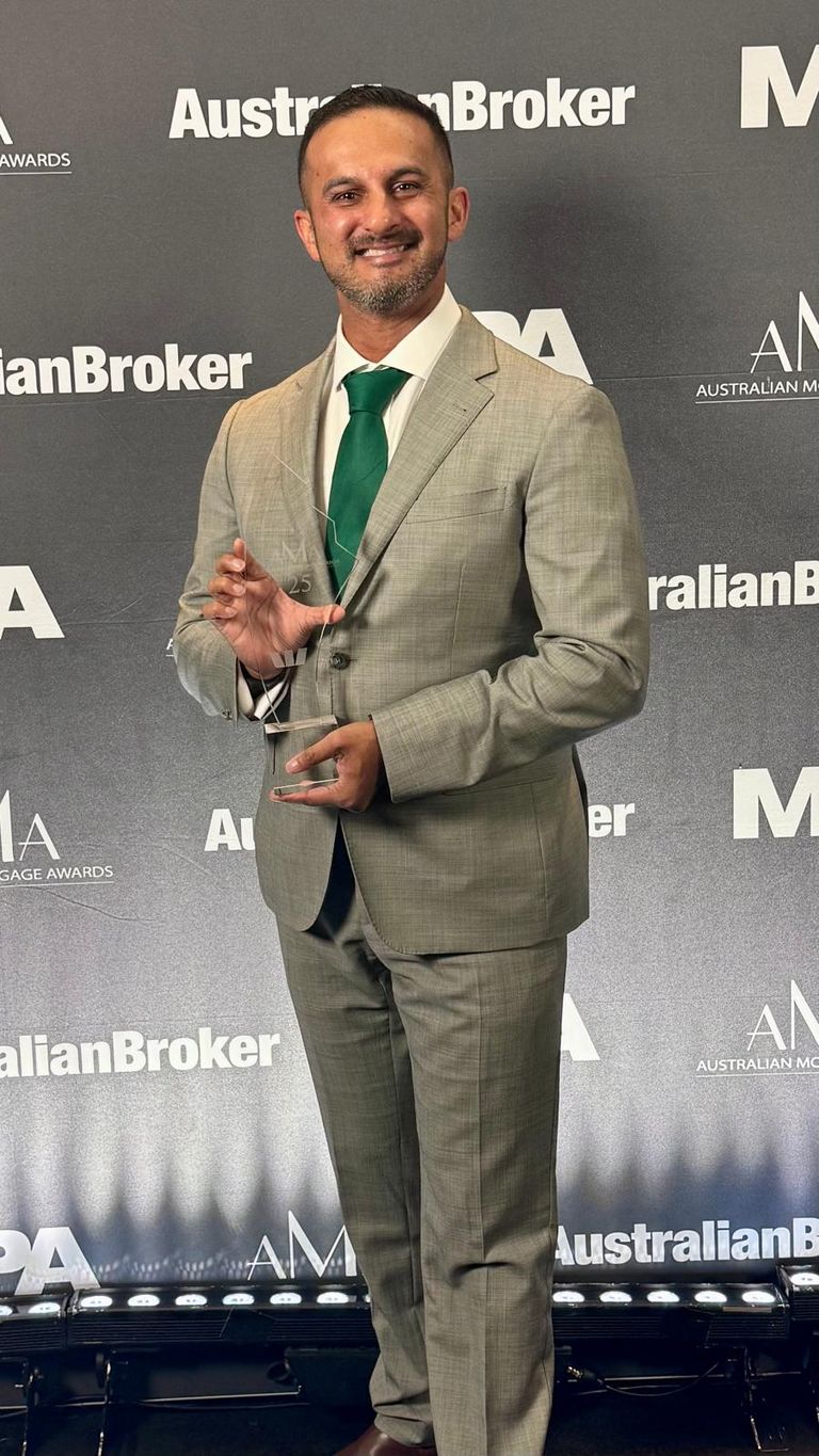 Dion Fernandes holding the 2025 AMA Broker of the Year award at the Australian Mortgage Awards